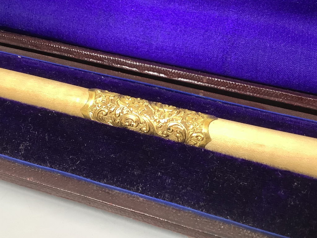 A yellow metal mounted conductor's baton, with monogram to handle base, in fitted case